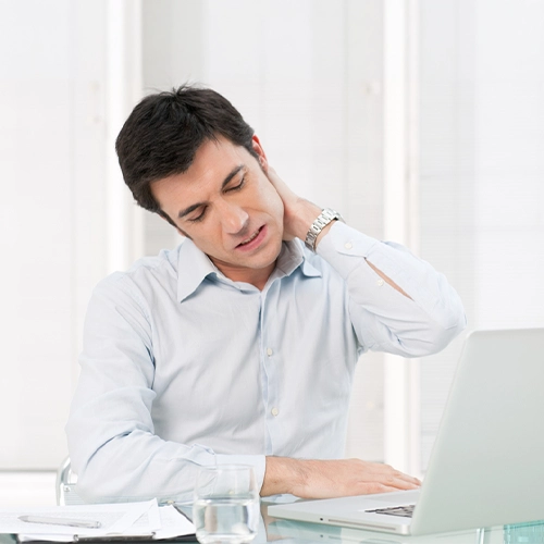 Man With Neck Pain At A Desk